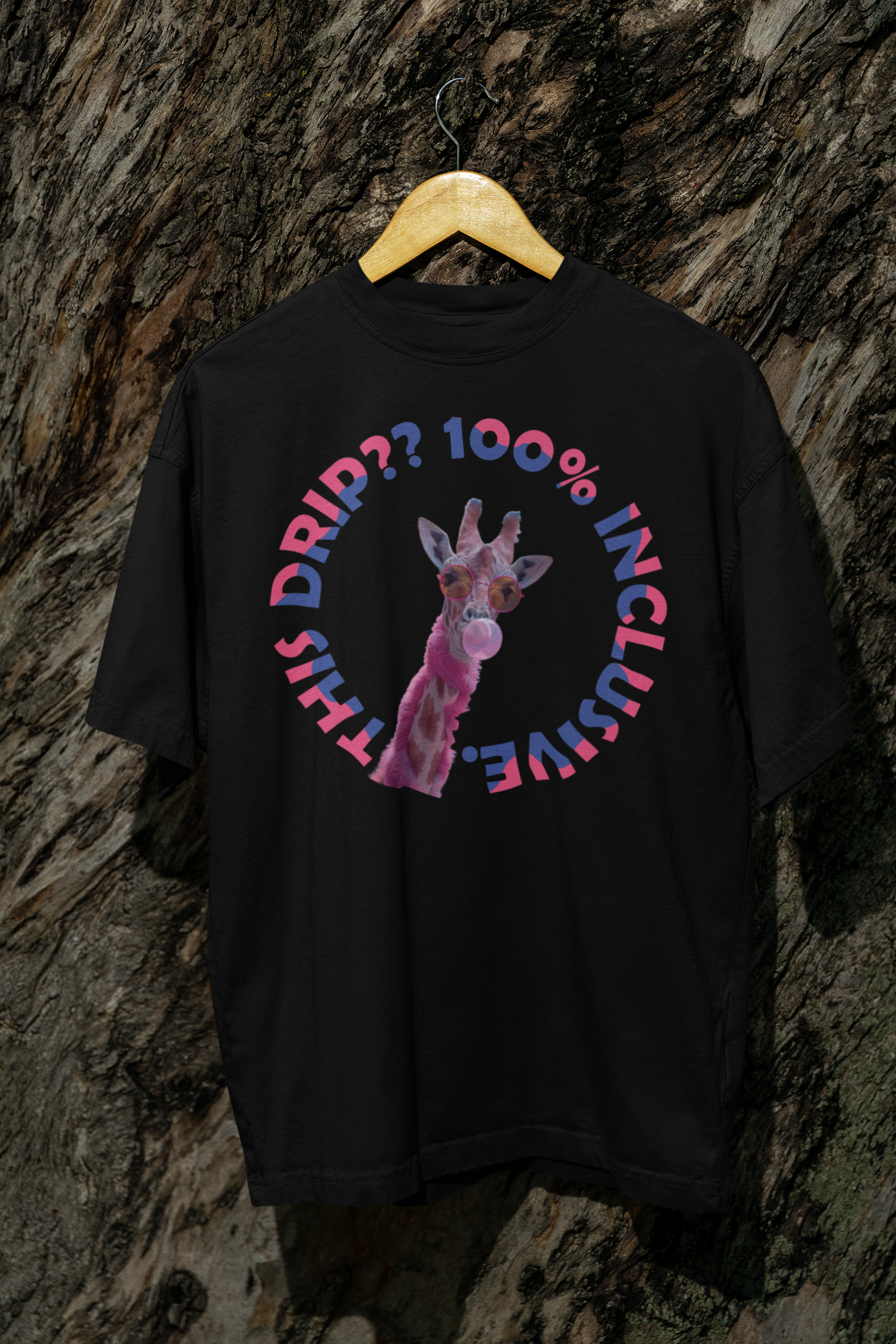 Black unisex graphic t-shirt featuring a vibrant pink giraffe with sunglasses and bubble gum, surrounded by the bold, rainbow-gradient text “THIS DRIP?? 100% INCLUSIVE.” Designed by ANTI to celebrate LGBTQIA+ pride, gender expression, and unapologetic self-love through fashion.