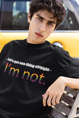"Model sitting in black oversized ANTI ‘I’m NOT’ T-shirt – unapologetic, gender-inclusive streetwear style."