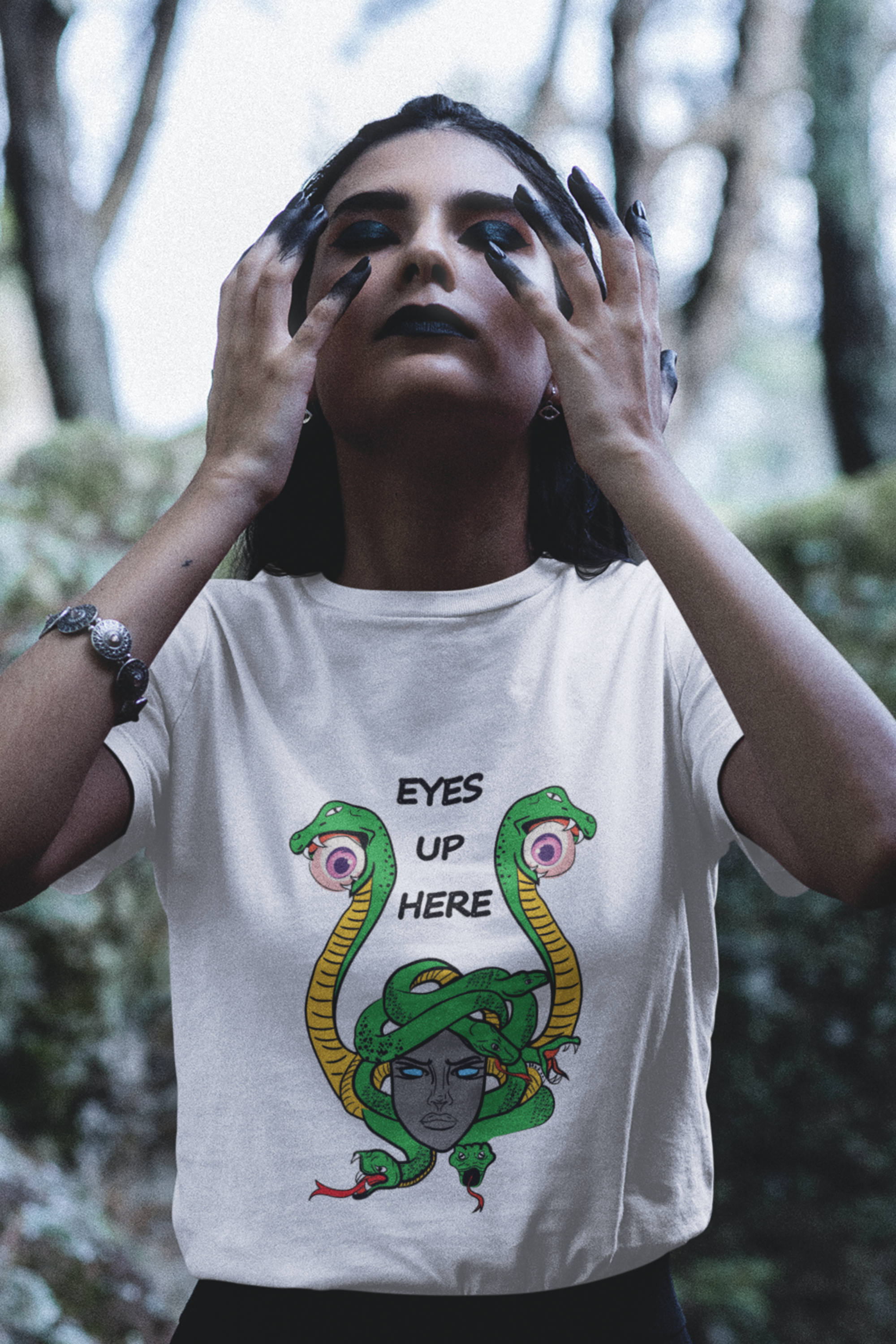 Minimalist white unisex T-shirt with “Eyes Up Here” slogan centered on the chest. Designed for gender-expansive expression, body autonomy, and inclusive fashion confidence.