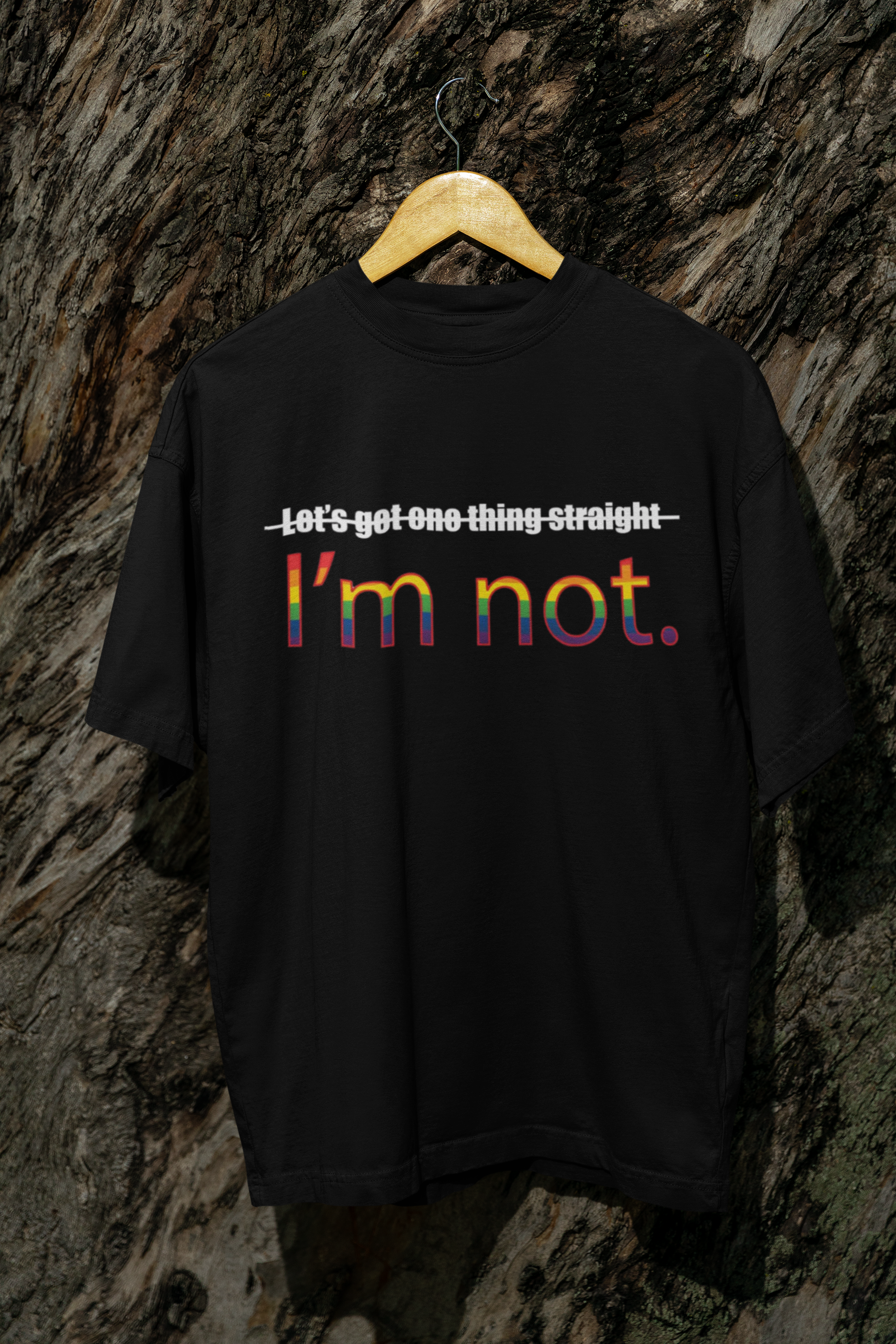 "Bold black ANTI tee with ‘I’m NOT’ slogan hanging flat – oversized queer fashion made for every gender expression."