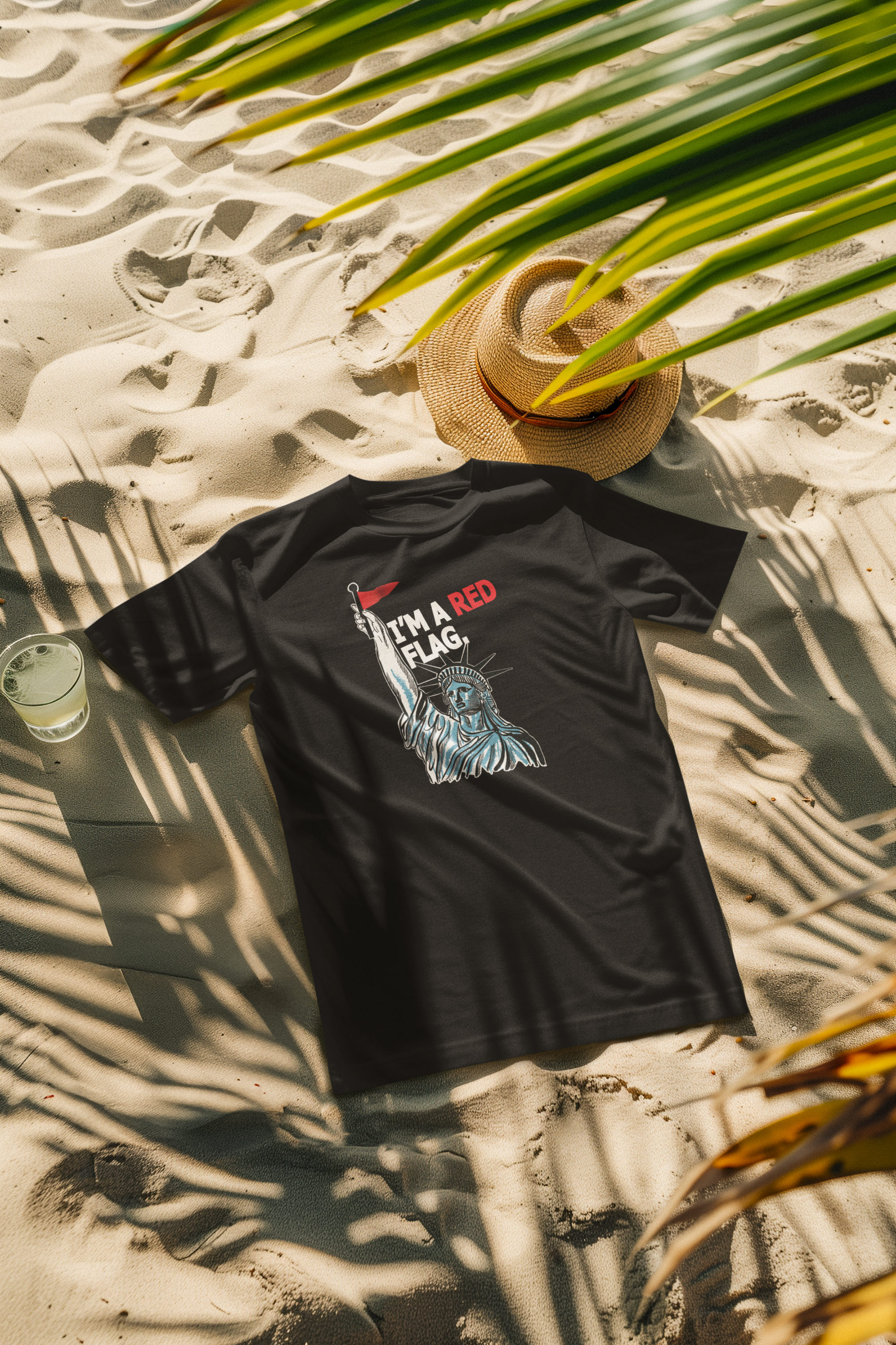 Black unisex t-shirt with contrasting white “I’M A RED FLAG” design showcased in a beach setting, representing ANTI’s gender-fluid, pride-forward fashion under the sun.