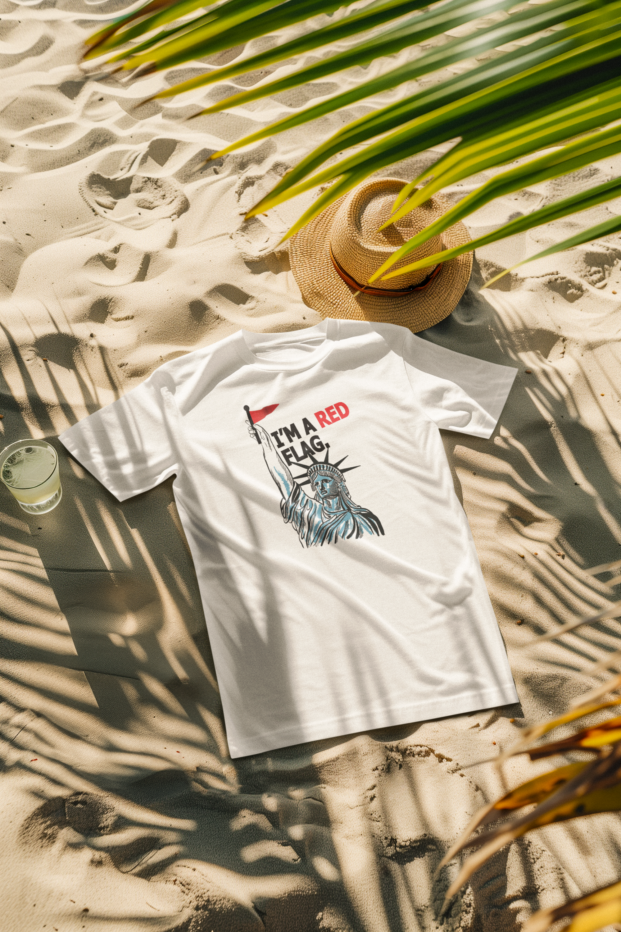 White unisex t-shirt with red “I’M A RED FLAG” print styled in a beach setting, reflecting ANTI’s bold LGBTQIA+-inclusive summer streetwear and unapologetic queer self-expression.