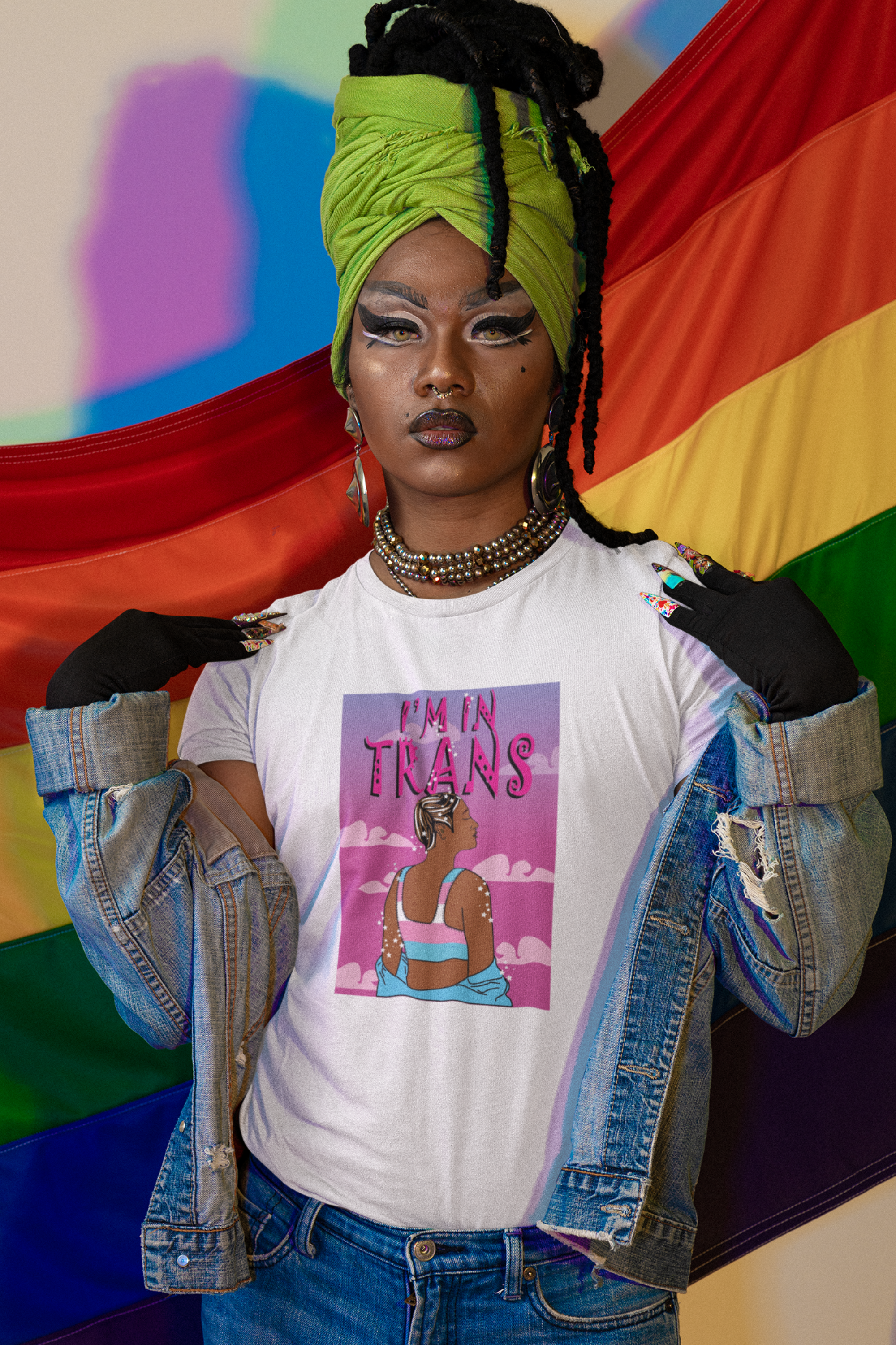 White unisex t-shirt with striking black "I’M IN TRANS" print, worn by a non-binary model; minimalist queer fashion promoting trans empowerment, from inclusive brand ANTI.