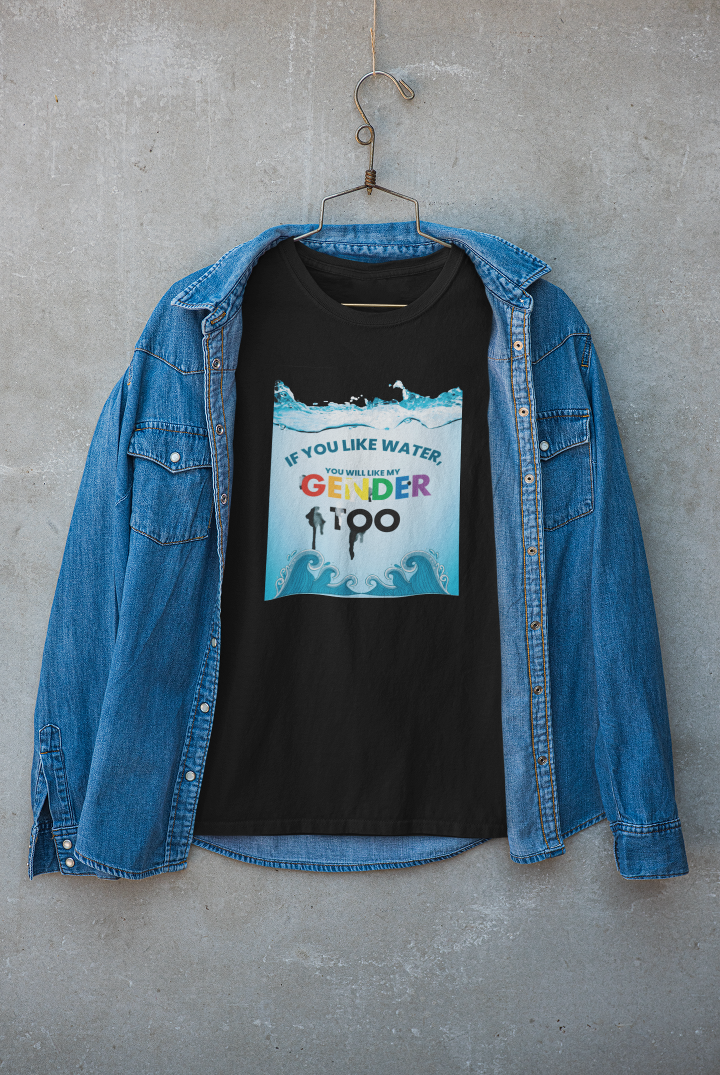 Black t-shirt under a layered outerwear look, boldly featuring the gender-inclusive message "If you like water, you will like my gender too"; from ANTI’s unapologetic streetwear for all genders.
