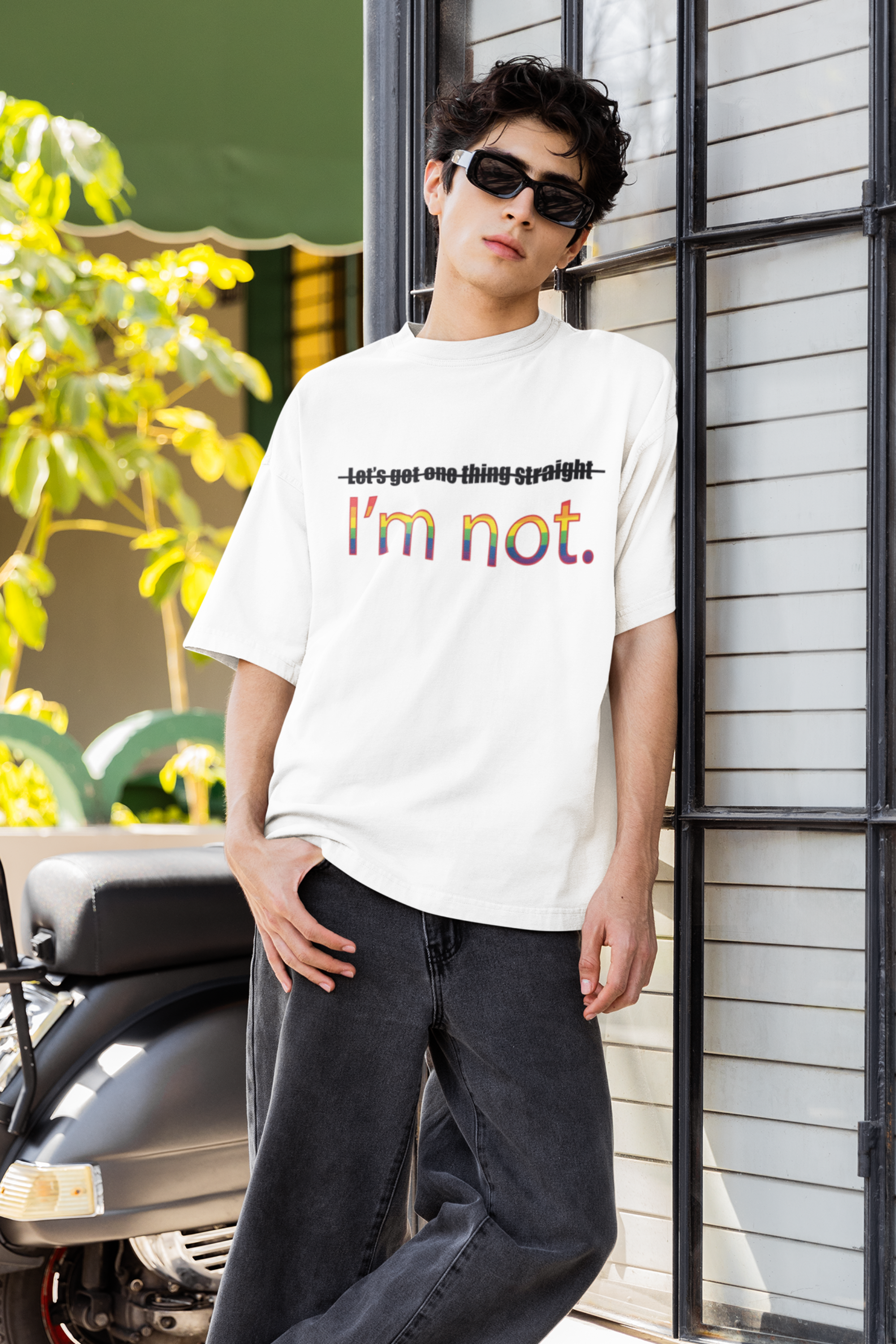 "Model in ANTI’s white oversized ‘I’m NOT’ shirt – gender-fluid, pride-affirming style for unapologetic self-expression."

