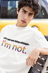 "Model sitting in white oversized ANTI ‘I’m NOT’ tee – queer-forward, gender-expansive pridewear."