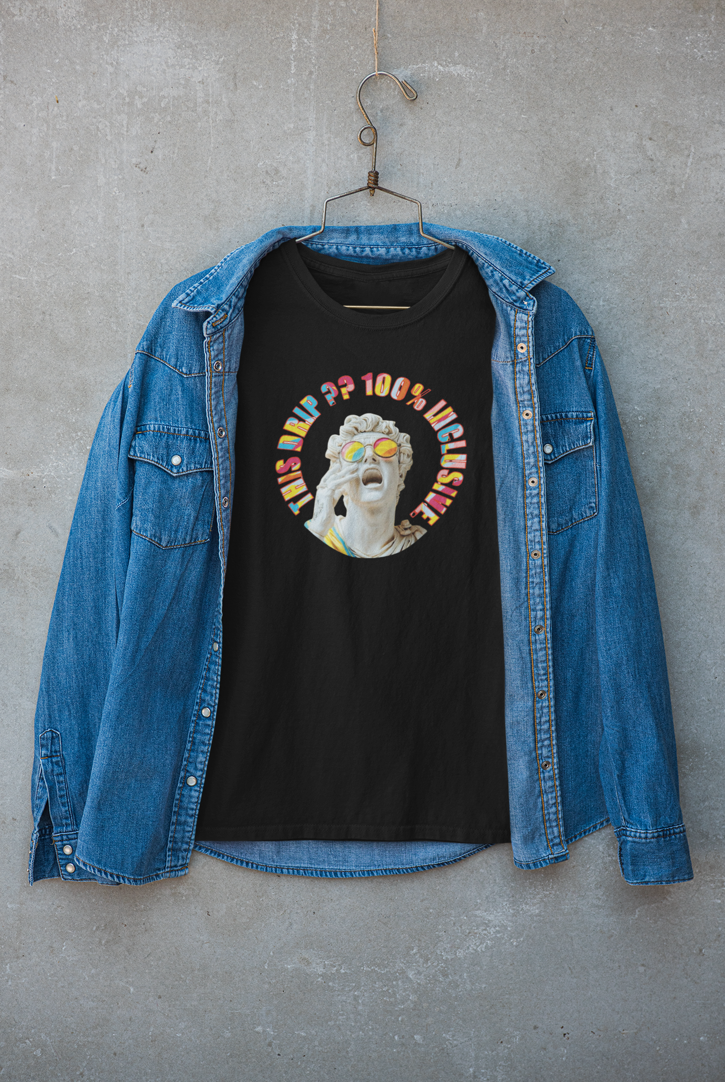 Black inclusive jacket by ANTI featuring “This Drip Is 100% Inclusive” slogan and man-with-glasses artwork; expressive urban fashion.