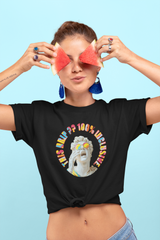 Black unisex t-shirt featuring bold “This Drip Is 100% Inclusive” slogan and illustrated guy with glasses; inclusive fashion design promoting diversity and self-expression.