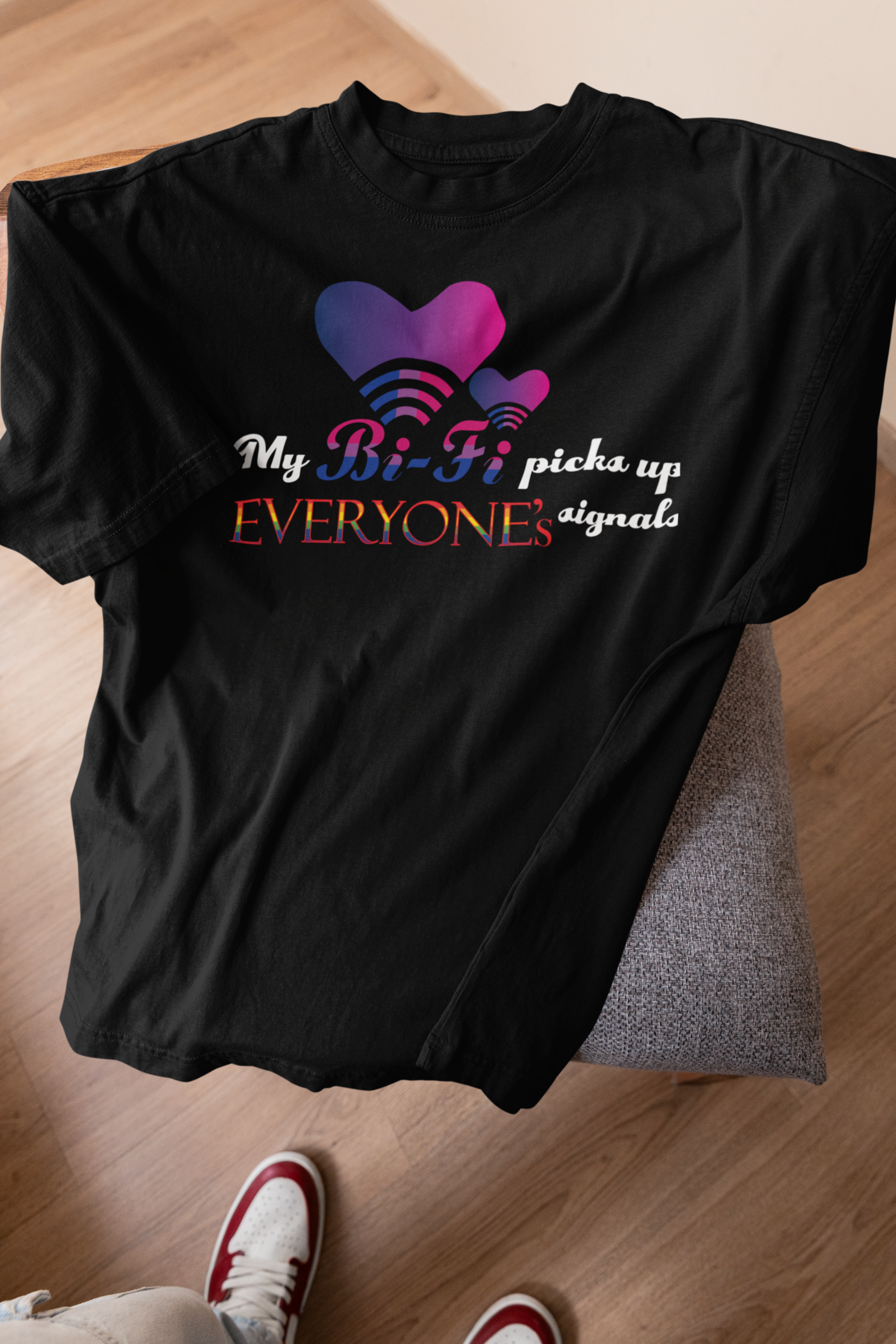 Black oversized My Bi-fi tee styled on stool, spotlighting queer-coded graphic and soft genderless cotton fabric.