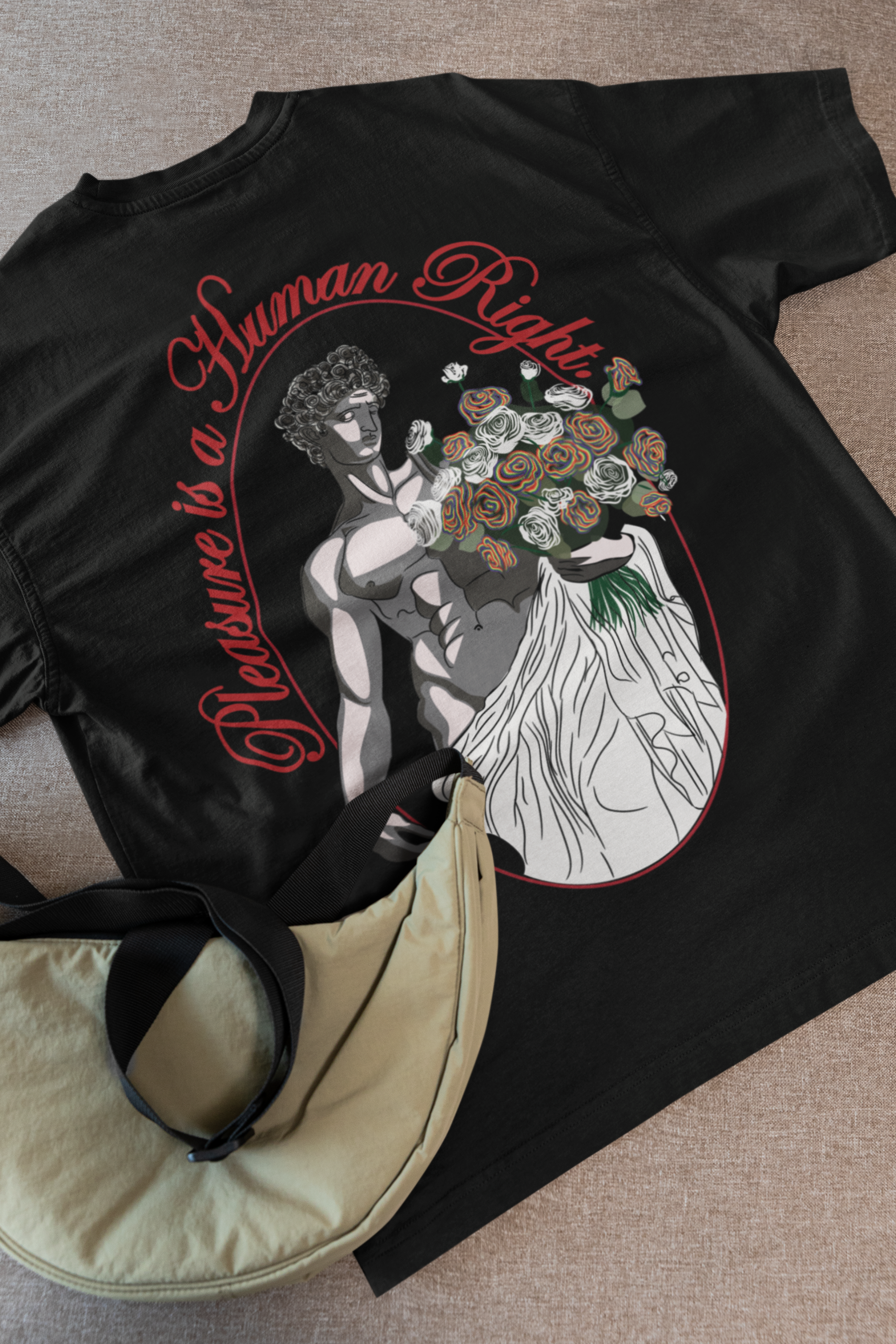 Flat lay of black oversized t-shirt featuring white "Pleasure is a Human Right" slogan, unisex and streetwear-inspired by ANTI.