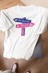 White oversized unisex T-shirt with “By Both Ways” slogan draped on a stool, designed for fluid expression