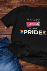 Black t-shirt featuring the phrase “In the world of LABELS, let's wear PRIDE” ` pair with Blue Denim. Inclusive, LGBTQ