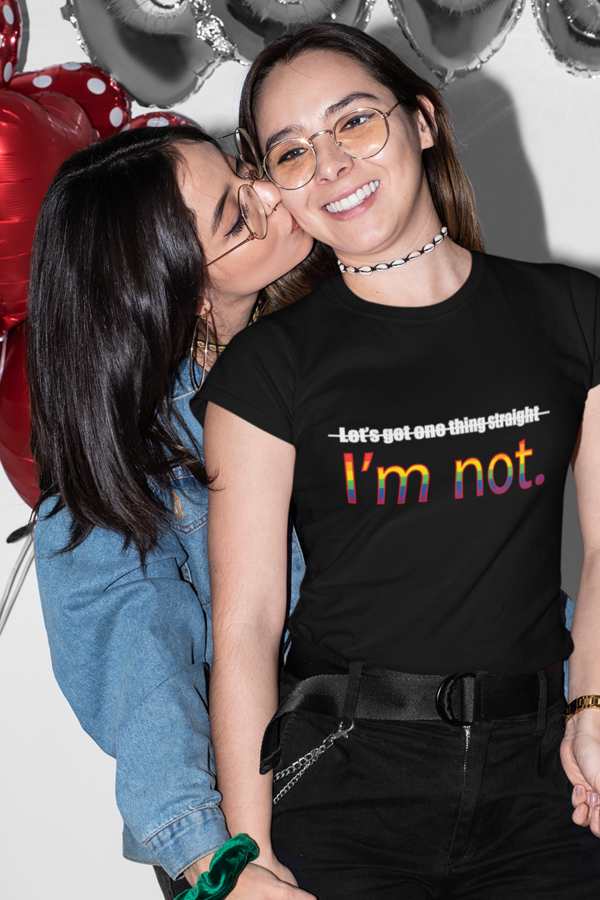 Flat-lay of a black unisex t-shirt with the iconic phrase "LET'S GET ONE THING STRAIGHT, I'M NOT" in crisp white text; designed for LGBTQIA+ visibility and inclusive fashion under the ANTI brand.