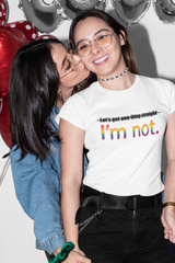 Flat-lay of a white unisex t-shirt with bold black print reading "LET'S GET ONE THING STRAIGHT, I'M NOT"; ideal for everyday queer expression and inclusive style from ANTI.