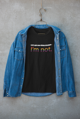 Black statement t-shirt styled beneath a jacket, with prominent white print reading "LET'S GET ONE THING STRAIGHT, I'M NOT"; photographed to highlight ANTI’s gender-inclusive aesthetic and unapologetic queer identity.