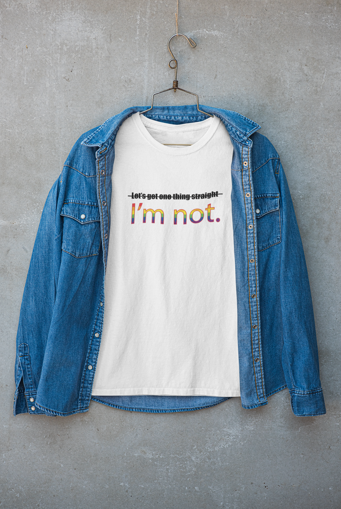 White t-shirt layered under a jacket, with the empowering LGBTQIA+ slogan "LET'S GET ONE THING STRAIGHT, I'M NOT" visible on the chest; styled for gender-fluid streetwear and queer confidence by ANTI.