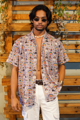 Man wearing a colorful patterned shirt with a wooden background