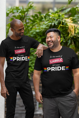 Two gender-diverse individuals wearing matching black ANTI t-shirts with the phrase “In the world of labels, let’s wear pride,” featuring rainbow flag accents. Perfect for LGBTQIA+ pride, inclusive identity expression, and bold, gender-fluid fashion.

