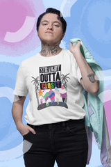Man wearing a white “Straight Outta Closet” t-shirt, standing confidently to celebrate LGBTQ+ pride and self-expression.