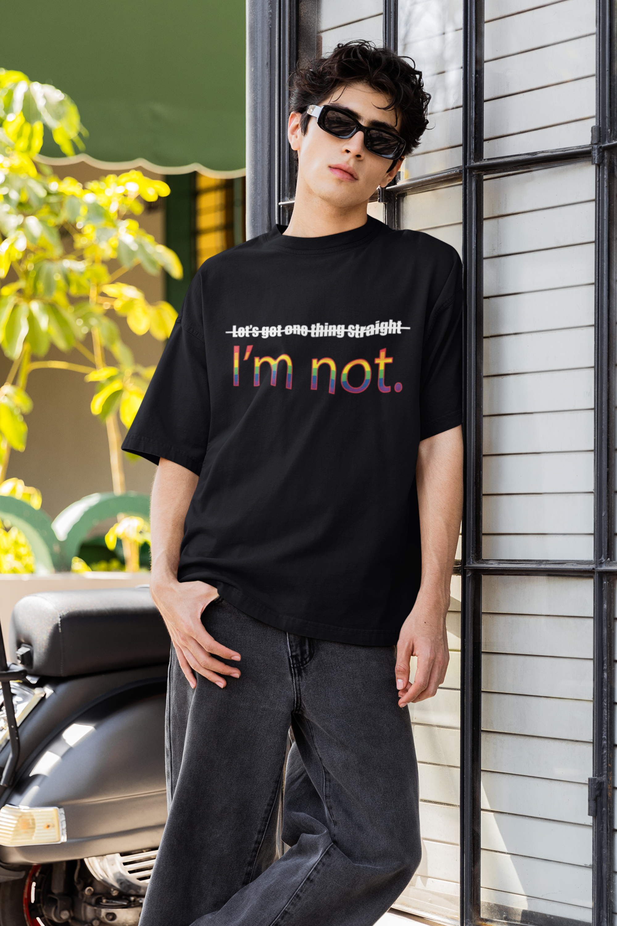 "Model in ANTI’s black oversized ‘I’m NOT’ shirt – edgy, queer-empowering fashion for gender-nonconforming expression."

