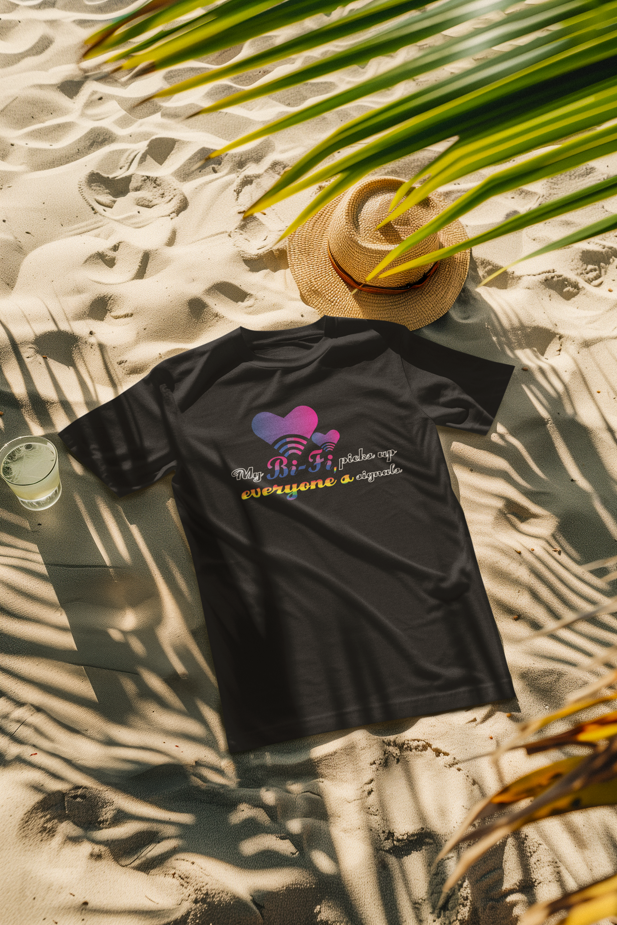 Beachside model in a black bisexual pride graphic tee reading “My Bi-Fi Picks Up Everyone’s Signal,” styled as inclusive summerwear that’s body-positive and gender-free.