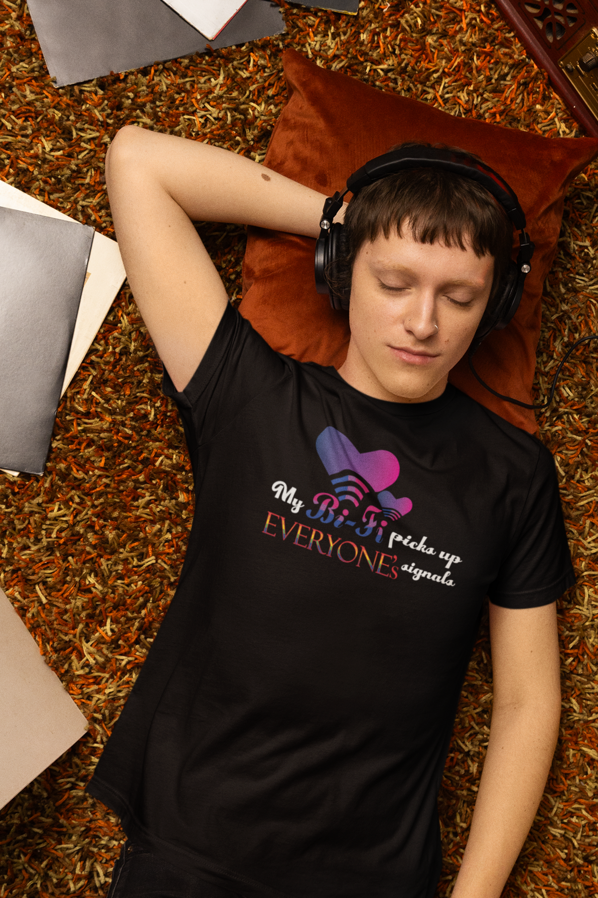 Model wearing a black unisex T-shirt with the bold slogan “My Bi-Fi Picks Up Everyone’s Signal” in vibrant, pride-themed lettering. A gender-inclusive, body-positive fashion piece celebrating bisexual identity and LGBTQIA+ visibility.