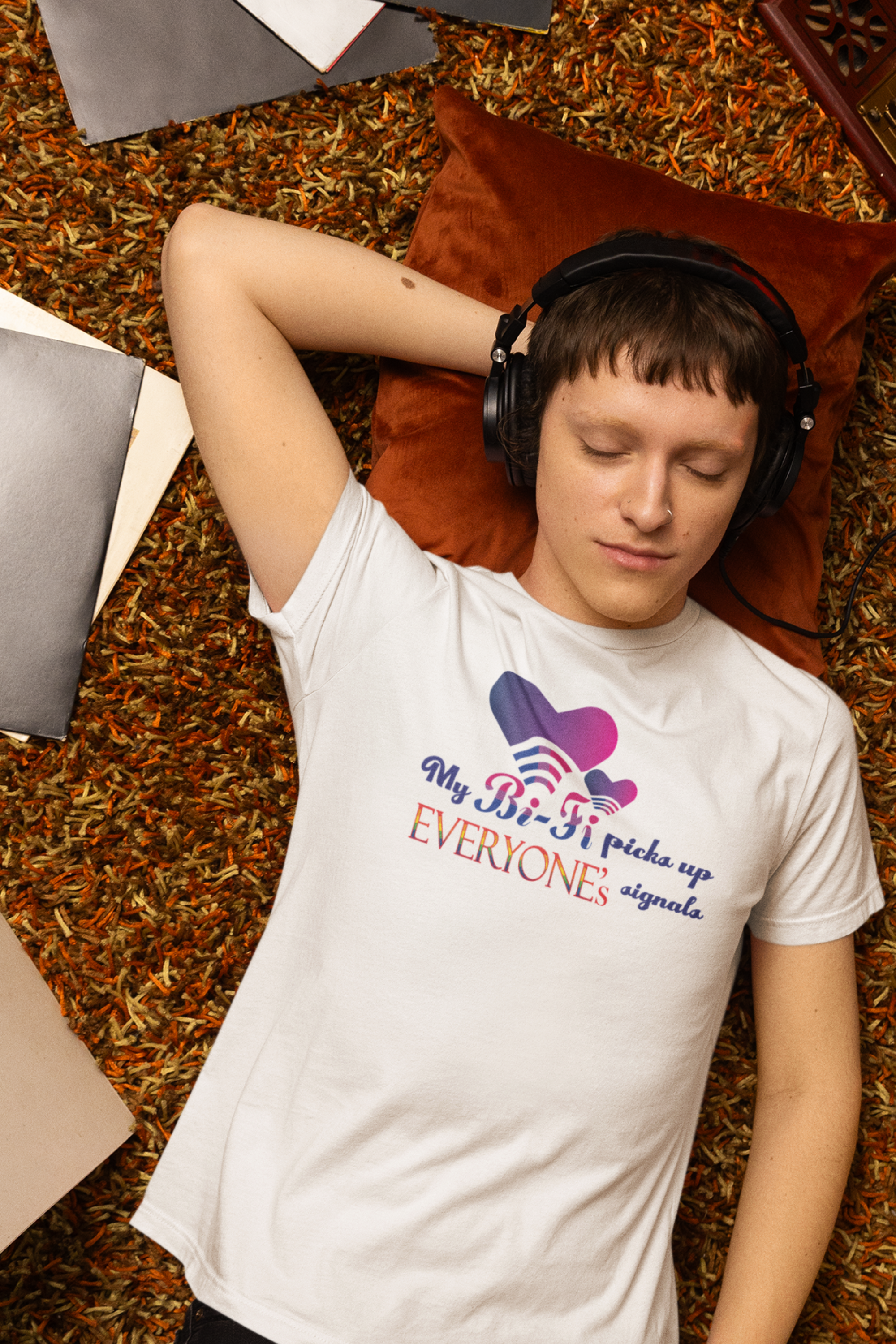 Person styled in a white, gender-neutral T-shirt featuring the empowering text “My Bi-Fi Picks Up Everyone’s Signal.” A bold and inclusive design highlighting queer identity and body diversity.

