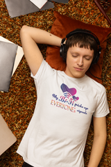 Person styled in a white, gender-neutral T-shirt featuring the empowering text “My Bi-Fi Picks Up Everyone’s Signal.” A bold and inclusive design highlighting queer identity and body diversity.

