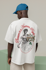 Model in white oversized t-shirt featuring “Pleasure is a Human Right” in black—queer-forward fashion, body-positive, and street-ready.

