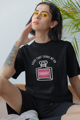 Back to the core. This black SCENT THAT TURNS ME ON tee in flat lay form reveals its clean, structured energy. Oversized and bold, it embodies anti-normativity with its striking typeface and universal fit. Crafted from smooth cotton, it’s perfect for layering or wearing loud. Built to break boundaries in style and identity.