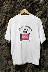 The white SCENT THAT TURNS ME ON tee, captured against nature, radiates ease and clarity. With soft fabric and a boxy silhouette, it’s a symbol of freedom and fluidity. Wear it to disrupt binaries, soften edges, and express identity with pride. A true wardrobe essential for the gender-expansive generation.