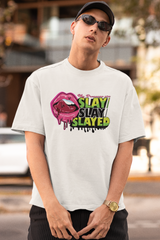 High-contrast white and black cropped jacket with “SLAYED” in bold urban font, worn confidently by a model representing ANTI’s inclusive, gender-expansive design ethos.