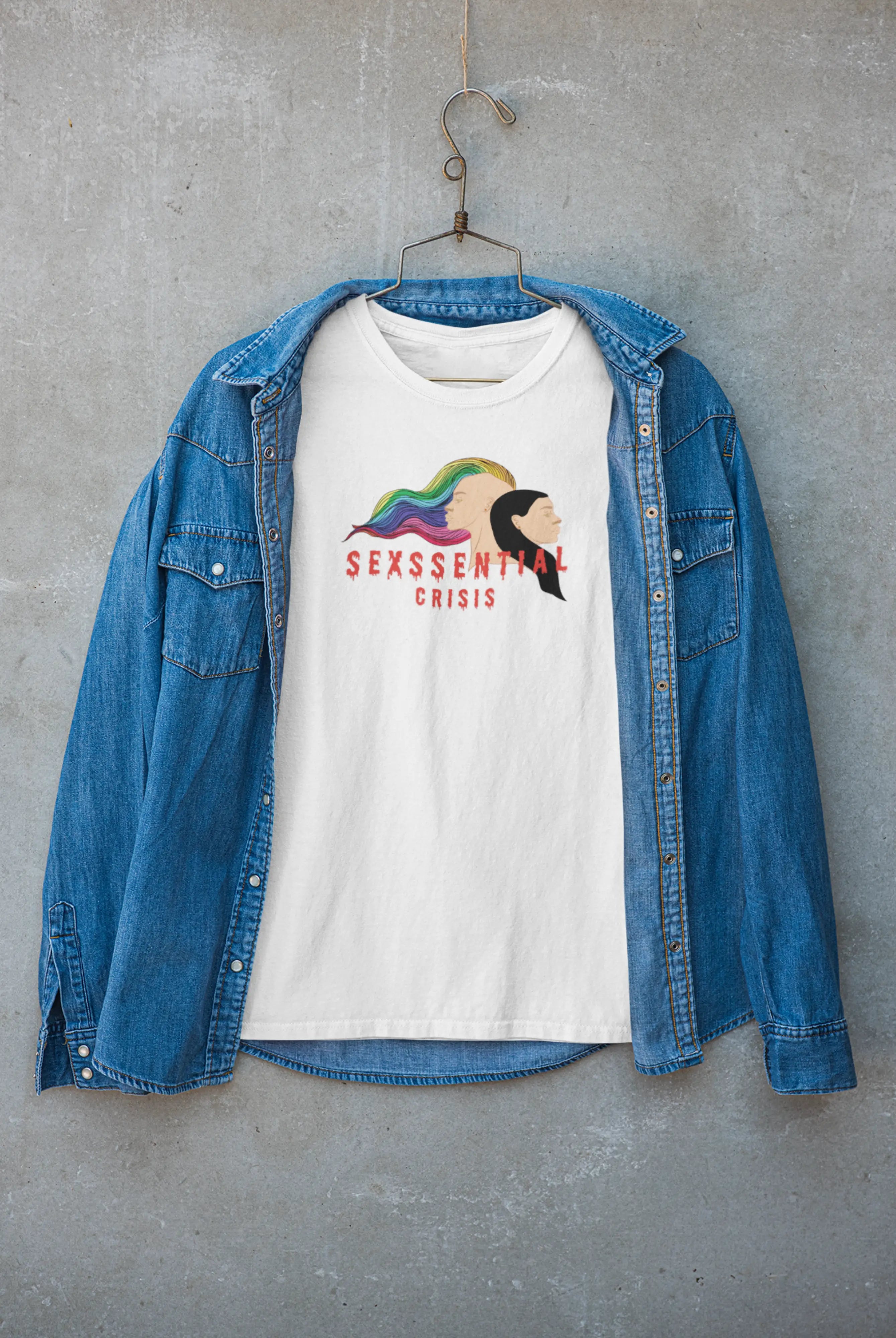 White gender-neutral T-shirt from ANTI with bold black twin-face artwork and “Sexssential Crisis” slogan, embracing queer identity, duality, and expressive minimalism in inclusive streetwear fashion.