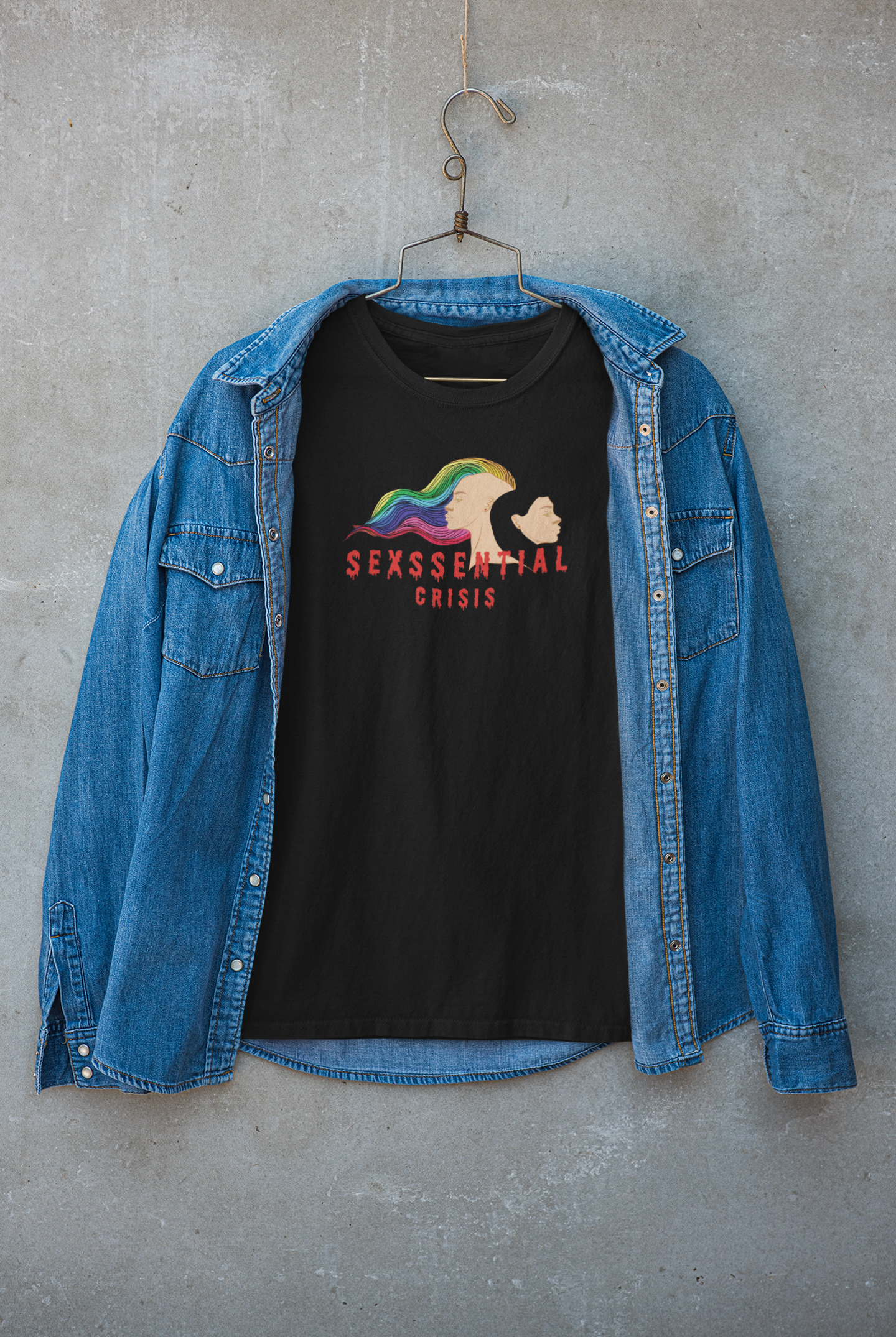 Layered look featuring ANTI’s black “Sexssential Crisis” tee beneath a jacket, styled for streetwear appeal with edgy graphic art of two heads and bold queer messaging, perfect for gender-fluid fashion lovers.