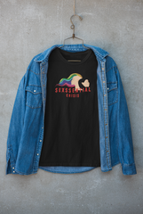 Layered look featuring ANTI’s black “Sexssential Crisis” tee beneath a jacket, styled for streetwear appeal with edgy graphic art of two heads and bold queer messaging, perfect for gender-fluid fashion lovers.