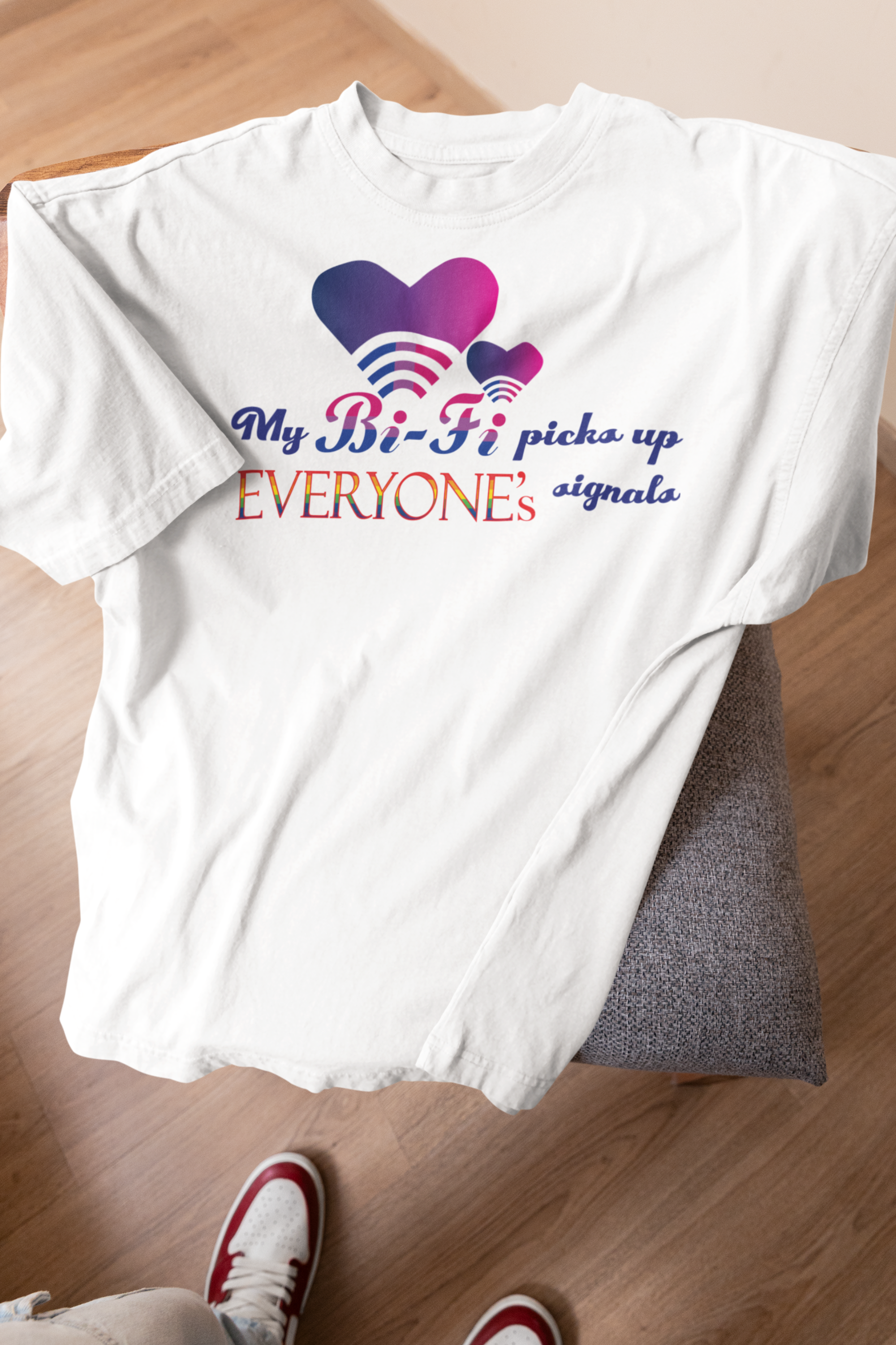 White My Bi-fi oversized tee draped over stool, highlighting minimalist layout and pride-forward bi+ message.