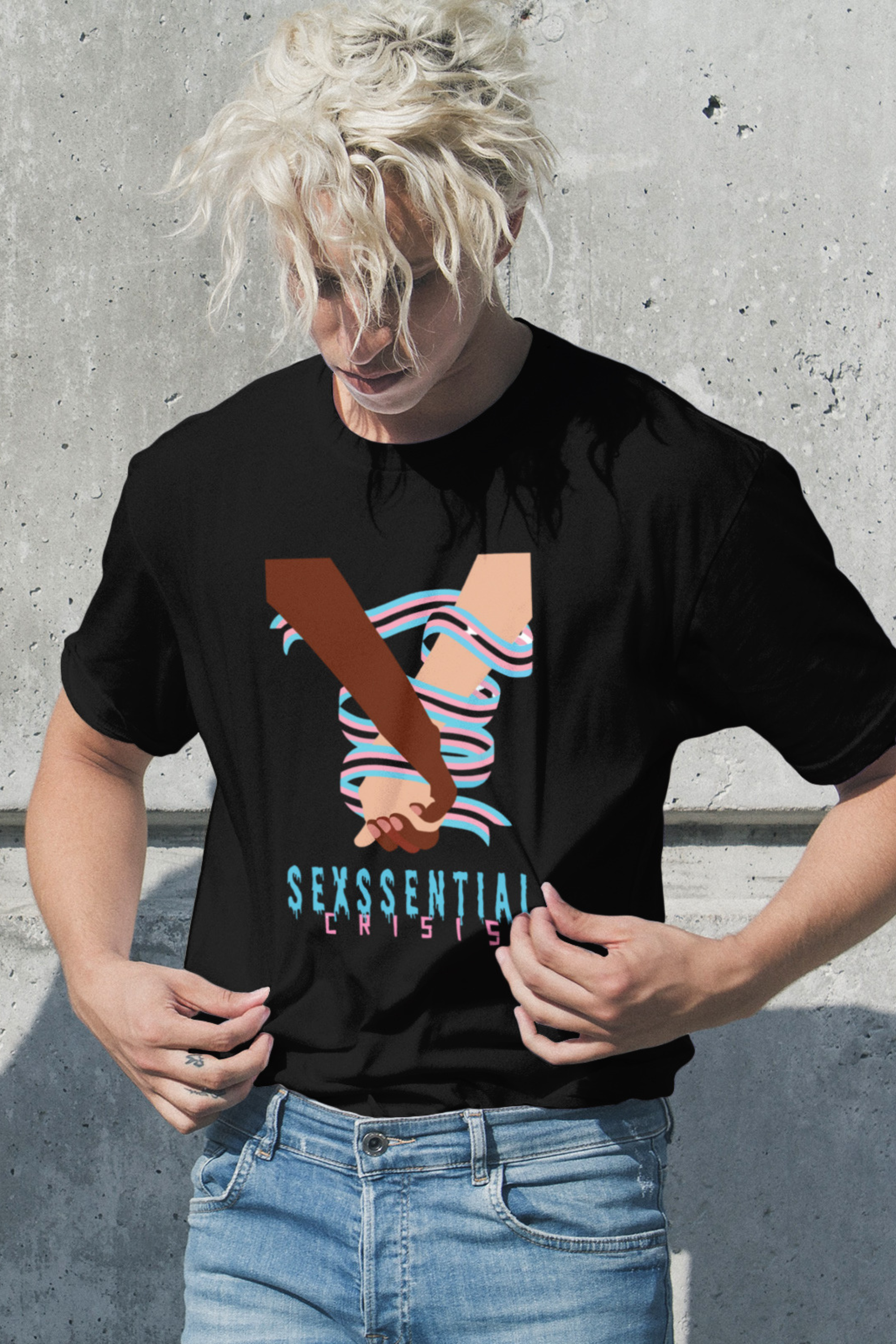 “Black unisex T-shirt by ANTI, featuring the iconic ‘Sexssential Crisis _ 2 Hands’ graphic design. Photographed in a coastal setting for a relaxed, edgy beach streetwear vibe.”