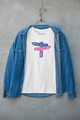 "Unisex white T-shirt from ANTI with 'By Both Ways' bisexual pride print, styled with a blue denim jacket on hanger – inclusive fashion promoting LGBTQIA+ visibility and identity."