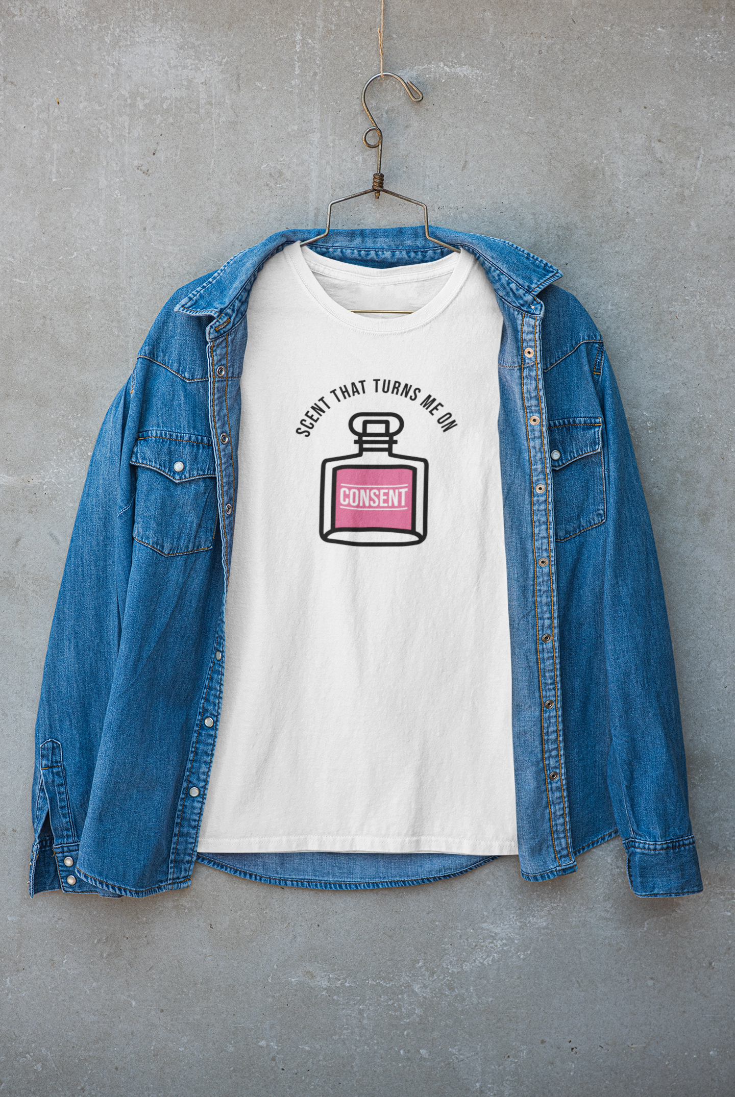 "White T-shirt styled for layering under jackets, printed with 'Scent That Turns Me On' – clean and chic statement fashion."
